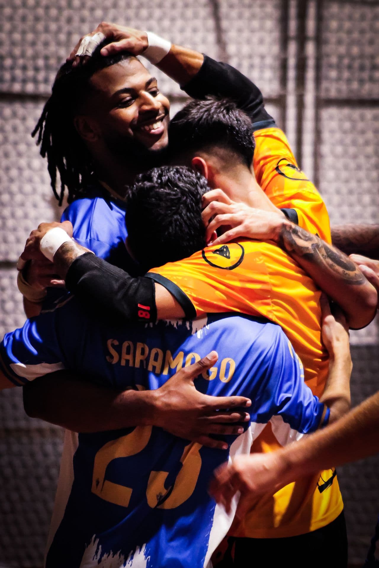 Players embracing to celebrate a goal